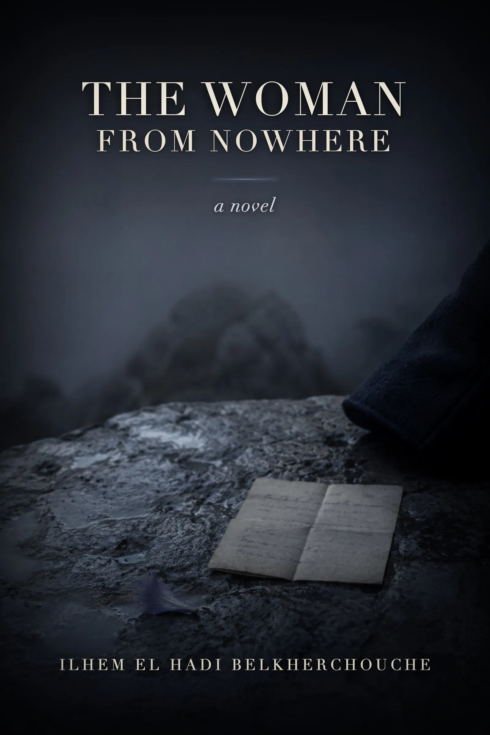 Cover of The Woman from Nowhere: a dark mountain gorge under mist, the title set small and pale near the top.